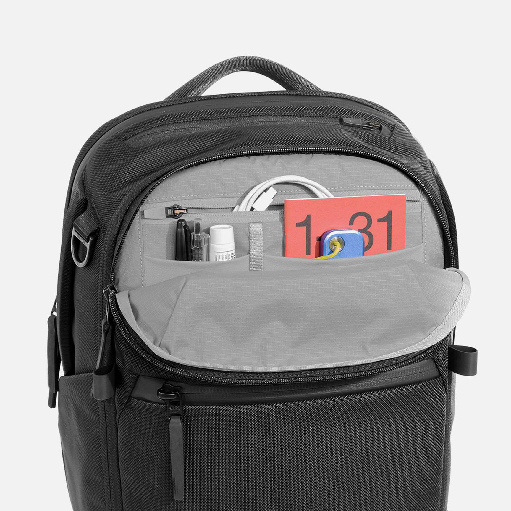 Black premium laptop backpack open inner compartment view, multi‑pocket organizer for pens cables documents business daily accessories